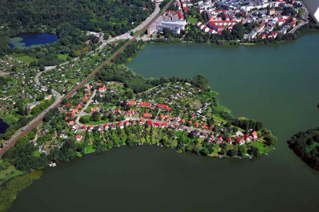 Das Luftbild, noch ohne die neue Brücke, zeigt die Siedlung auf dem Dwang – und die Eisenbahnstrecke.